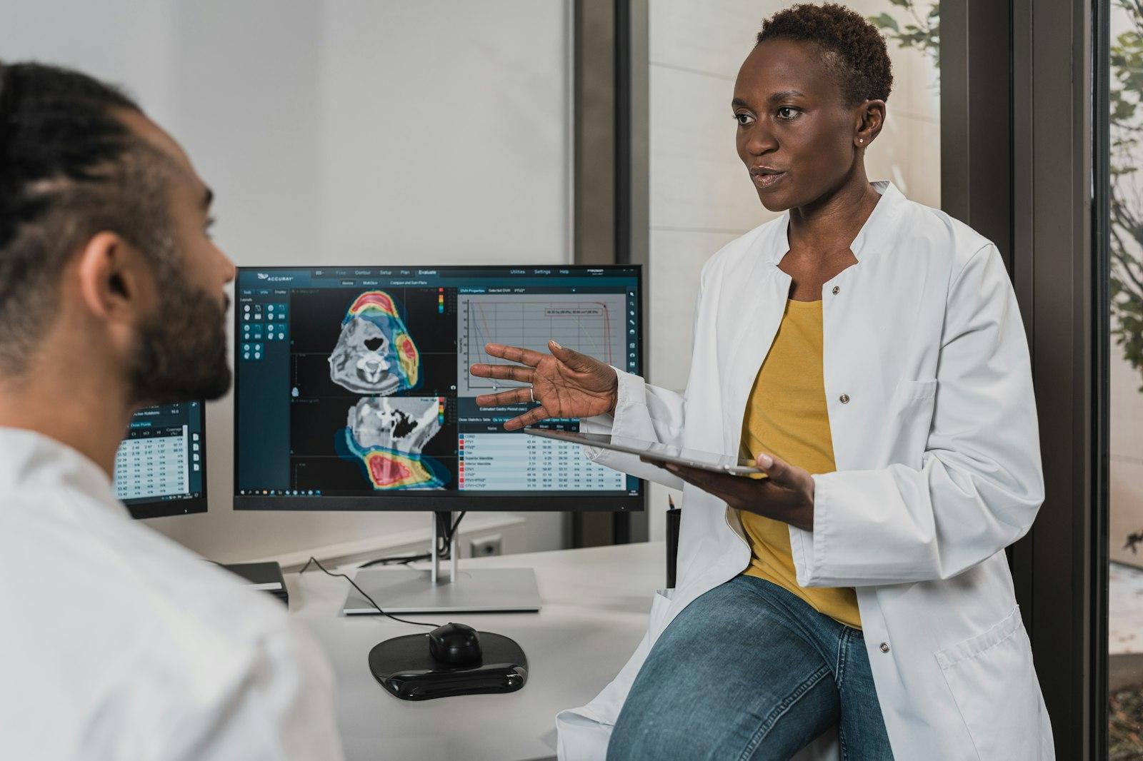 Two clinicians reviewing images at a diagnostic workstation