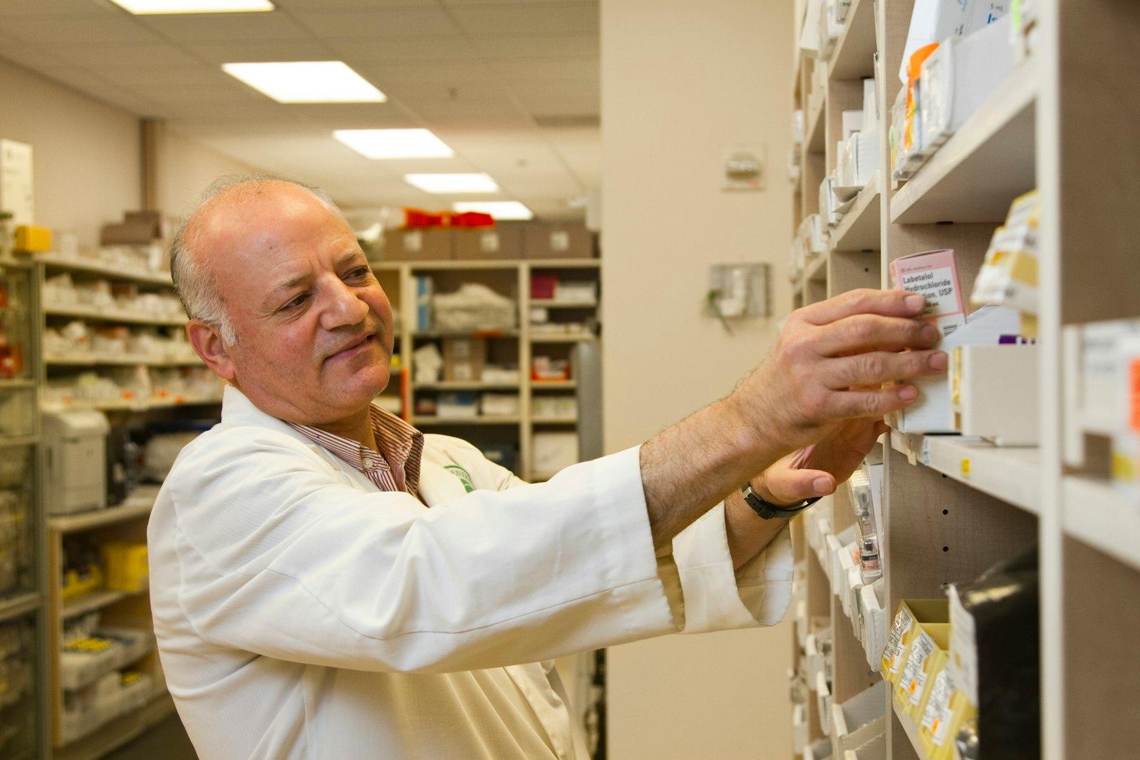 Clinician checking labelled stock on clinical shelving